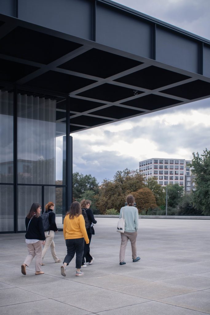 Visitors walking around the New national gallery towards a spacious patio