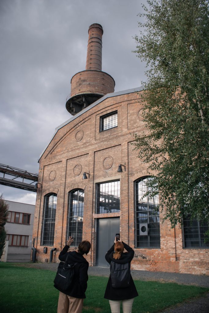 Visitors taking picture of the renovated coal mill, bricks and glass windows in this context feels majestic and modern